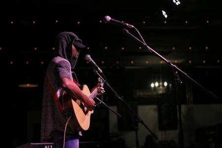 Emerick Lester, physical education and health major, performs during Open Mic Night in Barefoots Joe. - Photo by Hannah Heckart