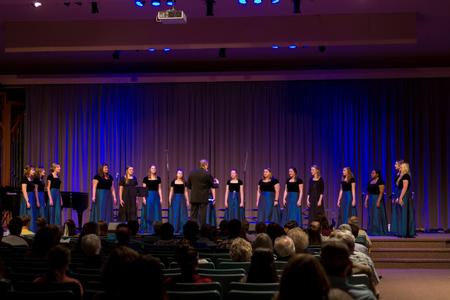 David Dennis, professor of music, conducts Cantilena during the Spring Choral Concert. - Photo by Nikki Grim