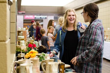 Guests enjoy perusing the student pottery offered at the annual Mother's Day Pottery Sale. - Photo by Jess Newendyke