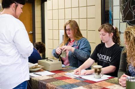 Art students wrap up purchases for shoppers of the annual Mother's Day Pottery Sale. - Photo by Jess Newendyke