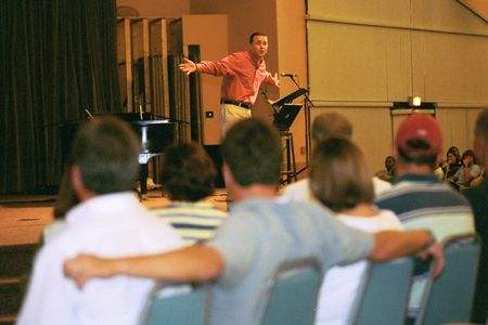 Minister to the University Todd Brady speaks to new students and parents during the FOCUS Worship service on Saturday night of New Student Orientation 2002. - Photo by Justin Veneman