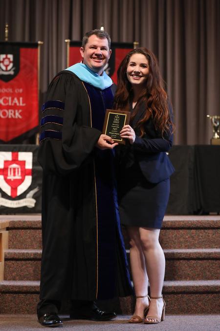 Bo Mantooth, director for student leadership and engagement, presents the Barnabas Leadership Award to Mikayla Simpson during Awards Day Chapel. - Photo by Kristi McMurry Woody