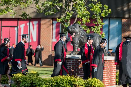 Undergrads process past the Buster statue into spring commencement.  - Photo by Kristi McMurry Woody