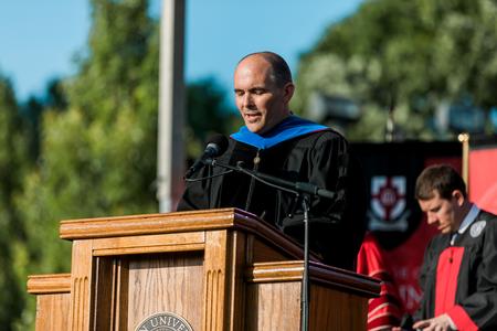 George Moss, professor of mathematics and department chair, prays at the beginning of spring commencement. - Photo by Kristi McMurry Woody
