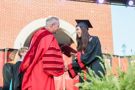 Elizabeth Caldwell, English graduate, receives her diploma from Dub Oliver, president of the university, during spring commencement. - Photo by Kristi McMurry Woody