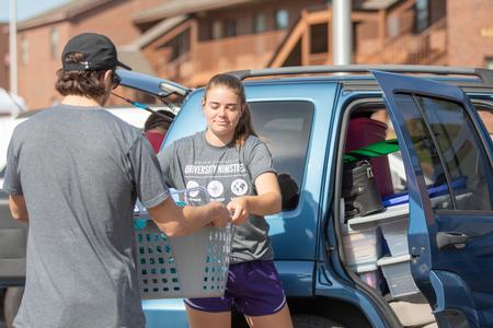 Upperclassmen help unload a new student's car during Move-in Day. - Photo by Kristi McMurry Woody