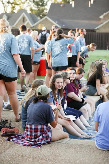 New students enjoy an ice cream social at the Olivers' house during Welcome Week. - Photo by Kristi McMurry Woody