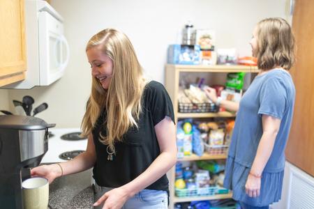 Callie Hauss and Morgan Ray, nursing majors, make coffee in their dorm room. - Photo by Kristi McMurry Woody