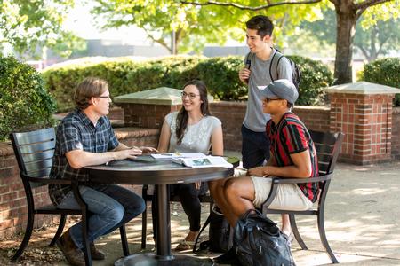 Steve Halla, associate professor of art, talks with students outside the PAC. - Photo by Kristi McMurry Woody