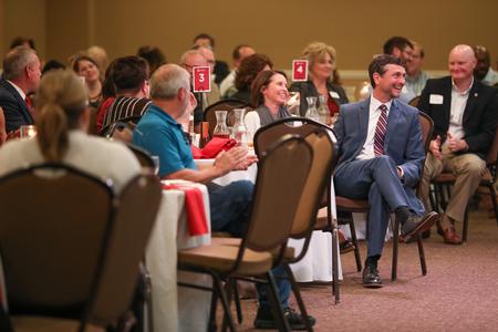 Mark Campbell laughs at a joke made during his introduction as the speaker for the Auxiliary Luncheon. - Photo by Kristi McMurry Woody