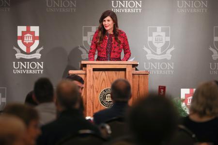 Susie Oliver, first lady of the university, leads the membership meeting portion of the Auxiliary Luncheon. - Photo by Kristi McMurry Woody