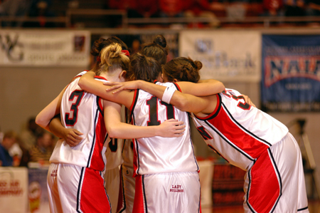 The five starters for Union hudle together prior to the opening tip of the title game in the NAIA Women's National Tournament. - Photo by Morris Abernathy