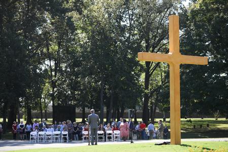 Dub Oliver, president of the university, talks to guests at the dedication of the cross outside the chapel. - Photo by Kristi McMurry Woody