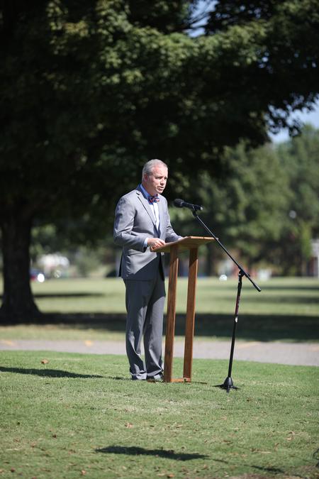 Dub Oliver, president of the university, talks to guests at the dedication of the cross outside the chapel. - Photo by Kristi McMurry Woody
