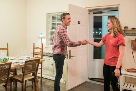 Jason Crawford, associate professor of English and faculty in residence, welcomes students to his home for Be Our Guest. - Photo by Kristi McMurry Woody