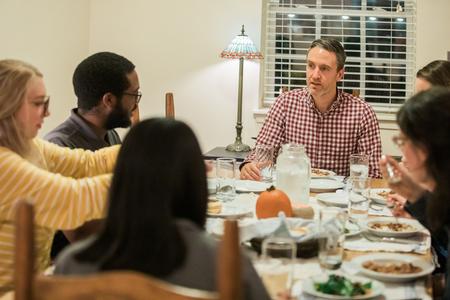 Jason Crawford, faculty in residence, enjoys conversation and dinner with students during Be Our Guest.  - Photo by Kristi McMurry Woody