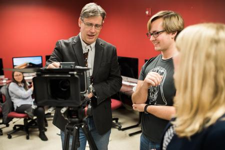 Chris Blair, professor of communication arts and coordinator of DMS, shows students one of the department cameras. - Photo by Kristi McMurry Woody
