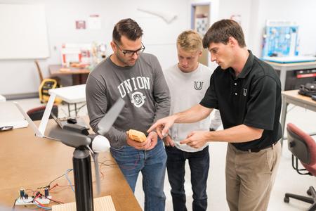 Georg Pingen (right), associate professor of engineering, works with some students in the lab. - Photo by Kristi McMurry Woody