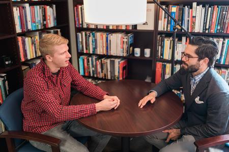 Jonathan Lafferty, Christian ministry and missions major, talks with Jacob Shatzer, associate dean of the school of theology and missions. - Photo by Kristi McMurry Woody