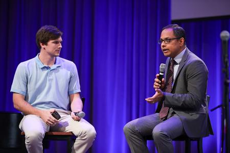 Stephen Neu, coordinator for service and mobilization, interviews Santhosh Abraham, associate professor of accounting, during chapel. - Photo by Kristi McMurry Woody
