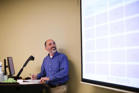 George Moss, associate professor of mathematics and department chair, leads a fun round of "Math Jeopardy."  - Photo by Kristi McMurry Woody