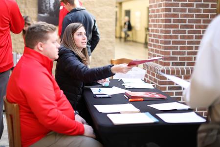 Morgan Sloan, senior enrollment counselor, hands out folders during STEM day. - Photo by Kristi McMurry Woody