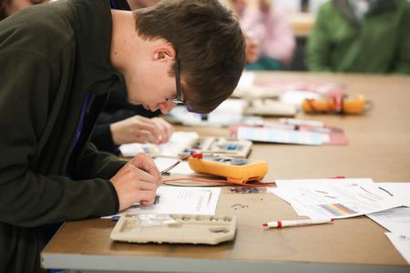High school students work on an engineering demonstration during a STEM visit day. - Photo by Kristi McMurry Woody