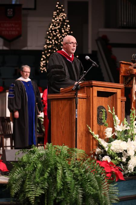 Kelvin Moore, university professor of biblical studies, reads scripture during fall commencement services.  - Photo by Kristi McMurry Woody