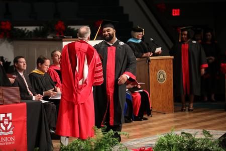 Graduates receive diplomas during fall commencement services.  - Photo by Kristi McMurry Woody