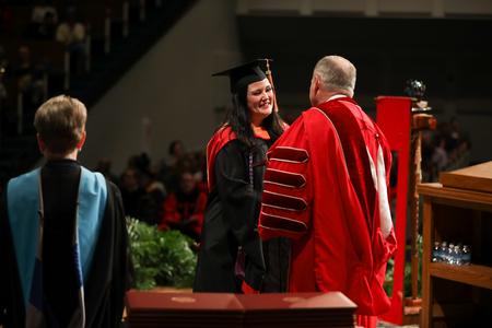 Students receive diplomas during fall commencement services. - Photo by Kristi McMurry Woody