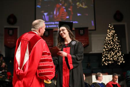 Jess Newendyke, art graduate, receives her diploma during fall commencement services. - Photo by Kristi McMurry Woody