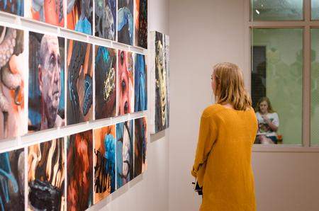 Students look at the work of alum Caleb Booth at the union art gallery.  - Photo by Jess Newendyke