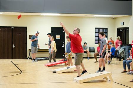Families participate in a cornhole tournament during Family Weekend in the Bowld Student Commons. - Photo by Jess Newendyke