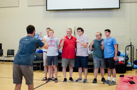 The winning families celebrate their victories after the Family Weekend cornhole tournament. - Photo by Jess Newendyke