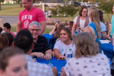 Students and their families enjoy the Chi Omega Make-A-Wish fundraising barbecue. - Photo by Nikki Grim