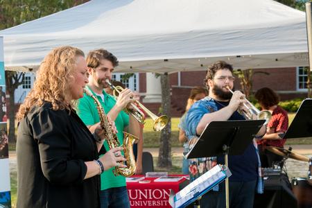 Kelly Garner, associate professor of contemporary voice and worship technology, and music students play for guests of Union Night during Family Weekend.  - Photo by Nikki Grim