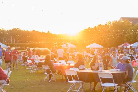The sun sets over the Great Lawn as guests enjoy Union Night during Family Weekend. - Photo by Nikki Grim