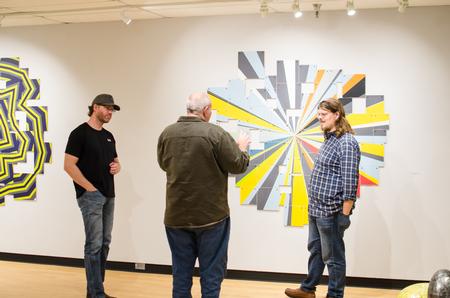 Guests admire the work of Gene Schmidt in the Union Art Gallery. - Photo by Jess Newendyke
