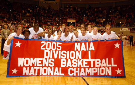 The entire Union Lady Bulldog team poses with the NAIA National Championship banner after Union win in the title game. - Photo by Morris Abernathy
