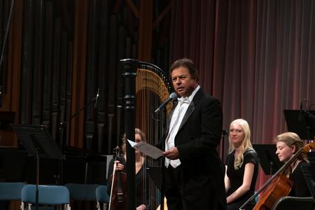 Michael Mann, assistant professor of music, greets guests at the Orchestra Concert. - Photo by Joey Echeverria
