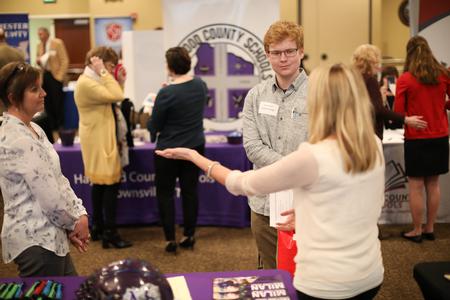Cameron Burgin, mathematics major, talks to recruiters during the Education Expo.  - Photo by Kristi McMurry Woody