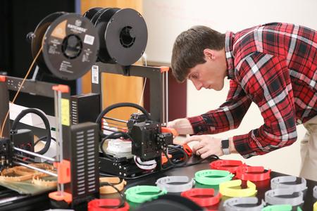Georg Pingen, professor of engineering, uses a 3D printer to make face shields for healthcare workers. - Photo by Kristi McMurry Woody