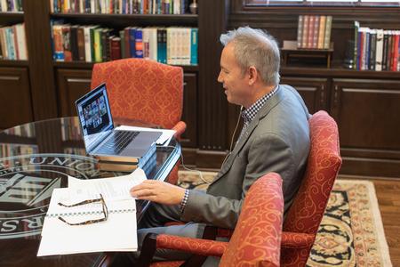 Dub Oliver, president of the university, conducts a board meeting from his office during a temporary campus closure.  - Photo by Kristi McMurry Woody