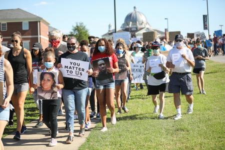 Faculty, staff, students and community members participate in a Walk for Justice. - Photo by Kristi McMurry Woody