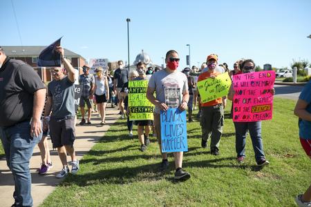 Faculty, staff, students and community members participate in a Walk for Justice. - Photo by Kristi McMurry Woody