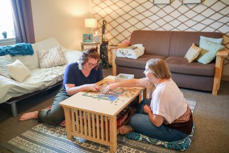 Students enjoy doing a puzzle in their dorm room. - Photo by Kristi McMurry Woody