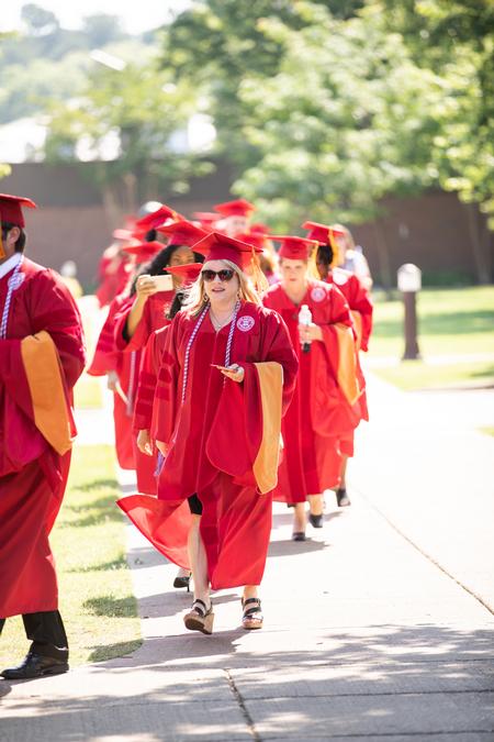 Jennifer Delk, assistant professor of nursing and chair for undergraduate programs, processes into Spring Commencement to receive her doctorate. - Photo by Kristi McMurry Woody