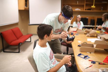 Georg Pingen, professor of engineering, helps a camper during the engineering 3D Printing Camp. - Photo by Kristi McMurry Woody