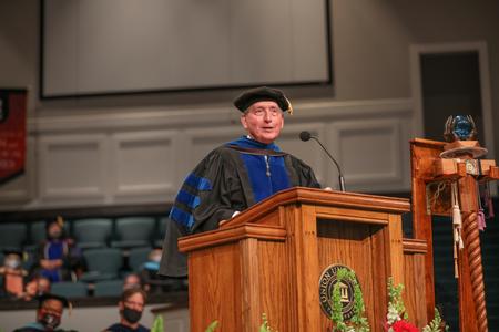 Tom Rosebrough, university professor of education, speaks during summer graduation. - Photo by Kristi McMurry Woody