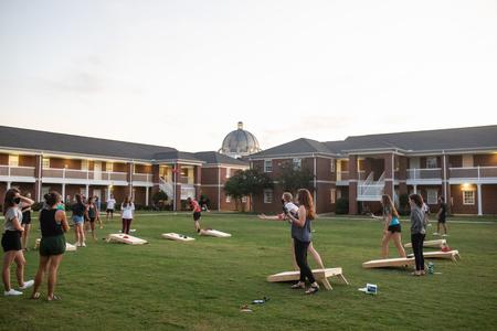 Students enjoy a corn hole tournament during the Labor Day Block Party outside the Bowld Commons. - Photo by Kristi McMurry Woody